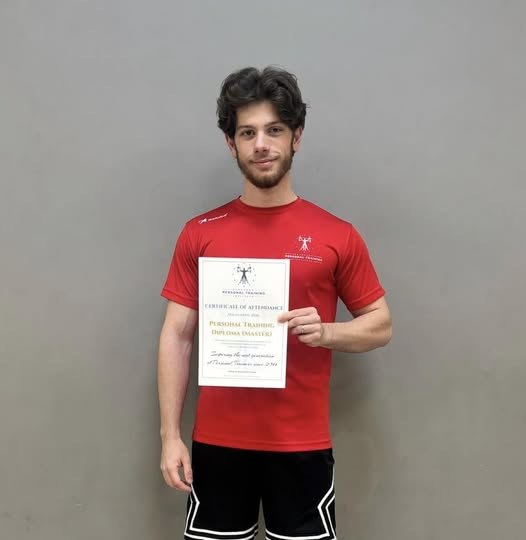 Christian Marshall holding a personal training certificate