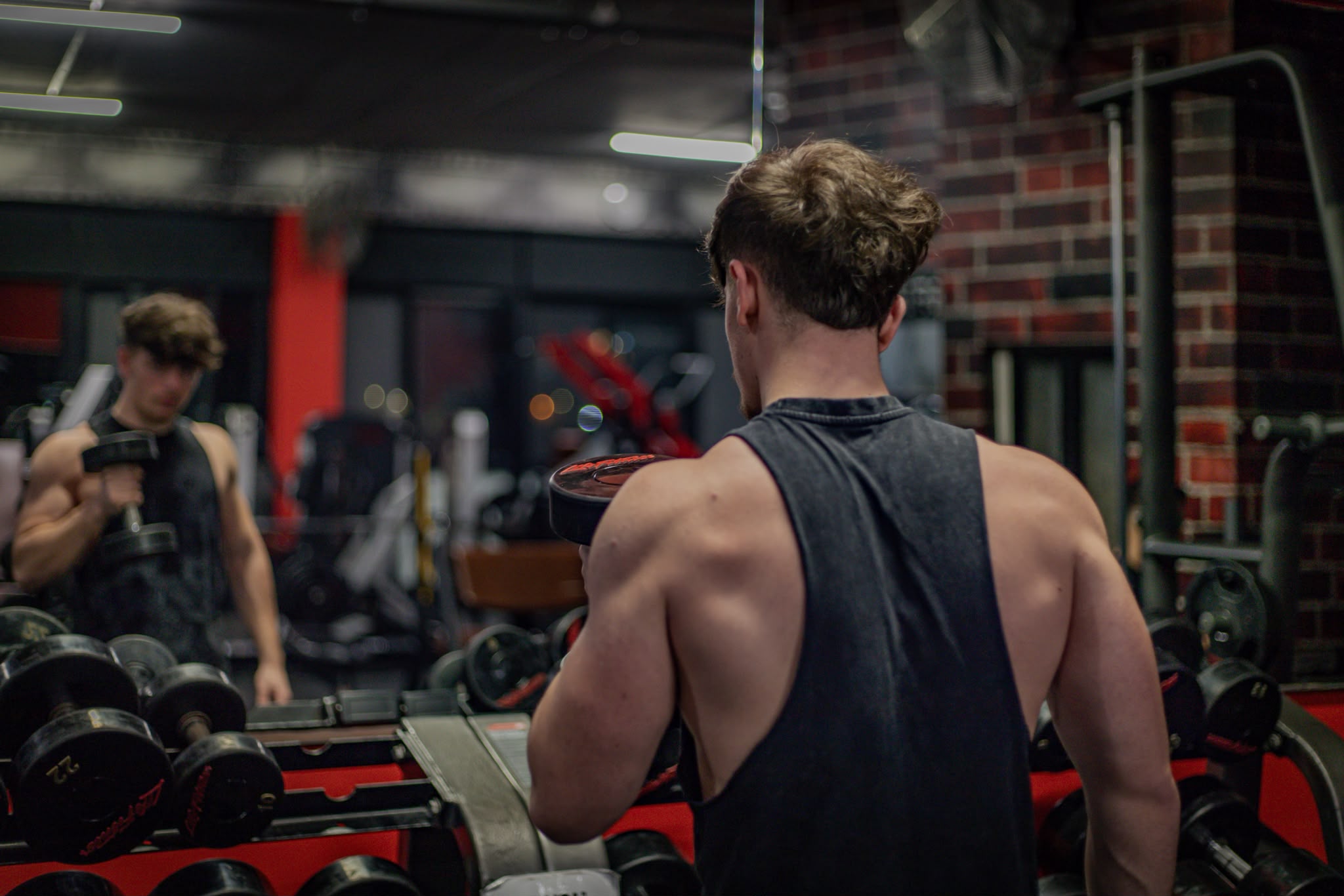 Client training with dumbbells during a coached gym session